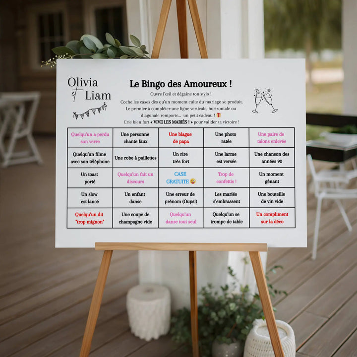 Panneau sur chevalet présentant un bingo de mariage avec une grille humouristique de moments à cocher pendant la fête, installé dans un lieu de réception bohème chic.